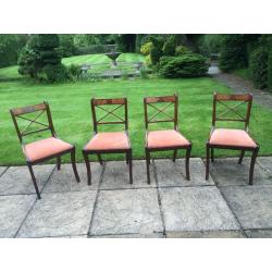 Four mahogany style dining room chairs with rust coloured pads 1980's