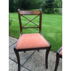 Four mahogany style dining room chairs with rust coloured pads 1980's