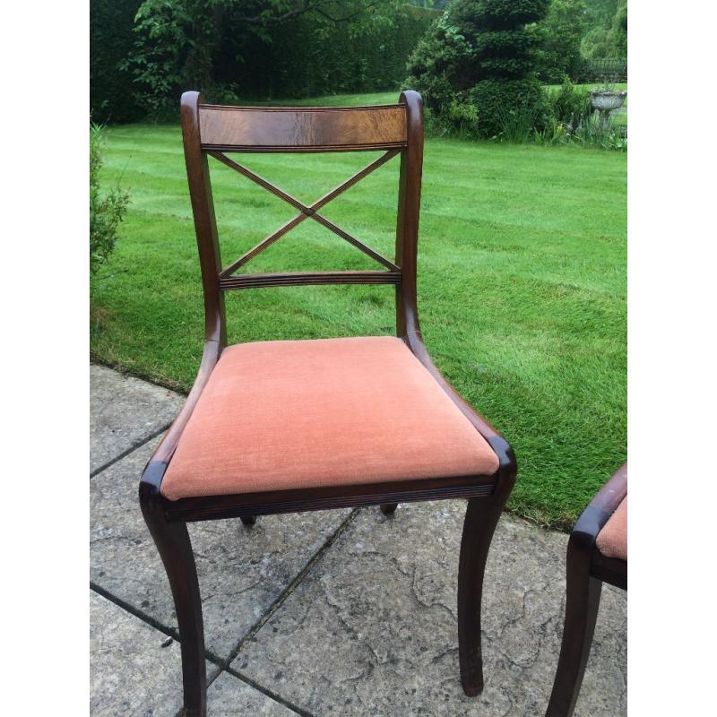 Four mahogany style dining room chairs with rust coloured pads 1980's