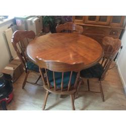 Great solid wood dining table and 4 chairs , also comes with matching wood and glass cabinet