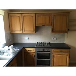 large Kitchen with solid wood doors, cooker, hob and buillt in extractor