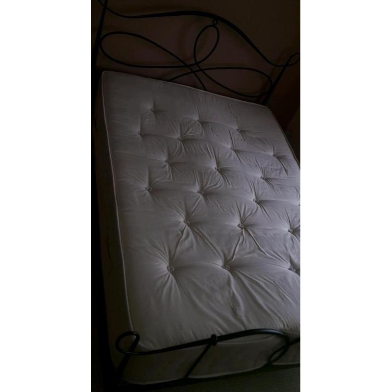 Double bed with metal frame and thick heavy mattress