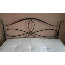 Double bed with metal frame and thick heavy mattress