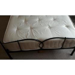 Double bed with metal frame and thick heavy mattress