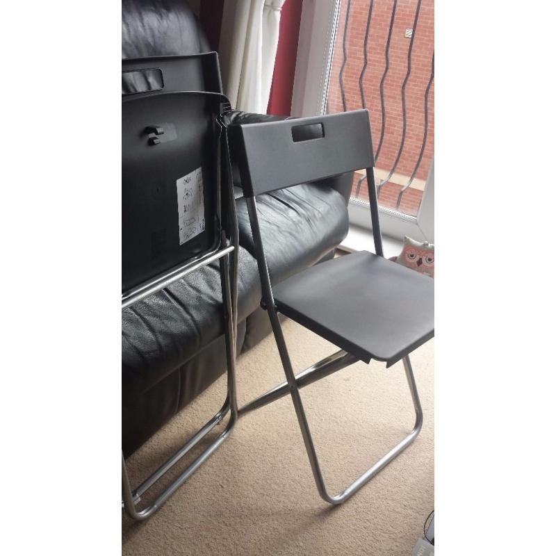 2 x black Ikea folding chairs with cushions