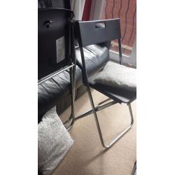 2 x black Ikea folding chairs with cushions