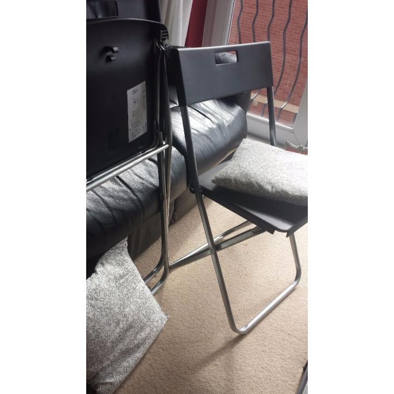 2 x black Ikea folding chairs with cushions