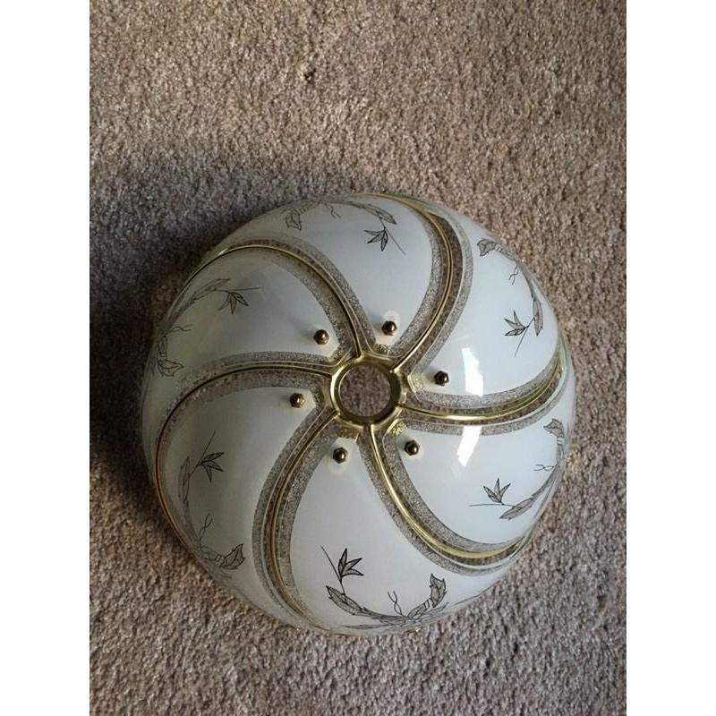 Glass light shade with gold coloured trim