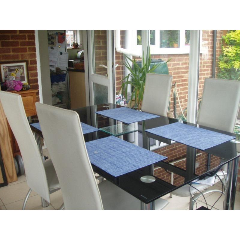 Black tempered glass and Chrome table, six chairs and matching bookshelf