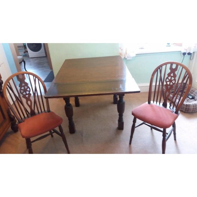 Dark oak dining table and 4 wheelback chairs