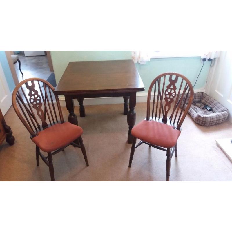 Dark oak dining table and 4 wheelback chairs