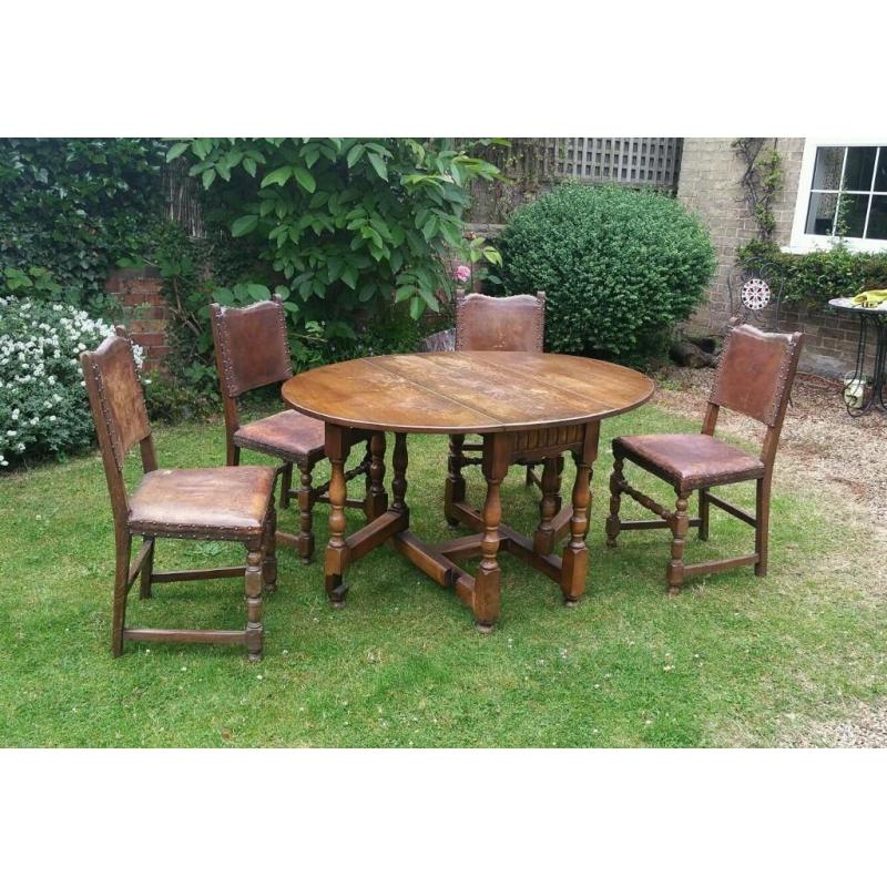 Solid oak table with 4 oak leather upholstered chairs