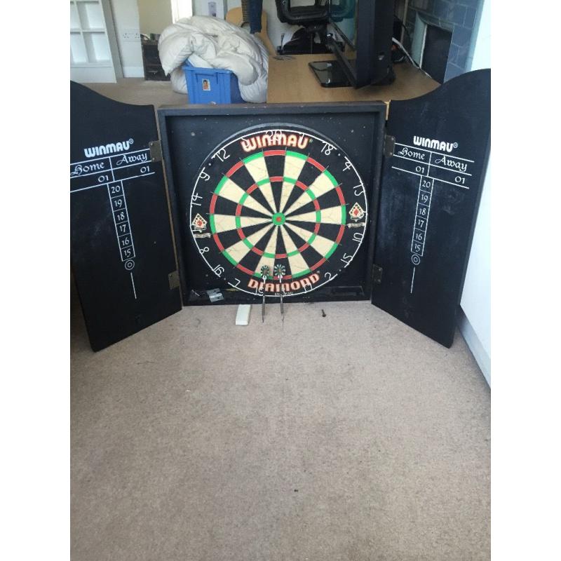 Winmau Dartboard in wooden cabinet.